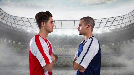 Composition of two male football players crossing arms over sports stadium. sport and competition concept digitally generated image.